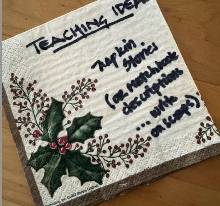 A holiday cocktail napkin with writing that says "TEACHING IDEA"